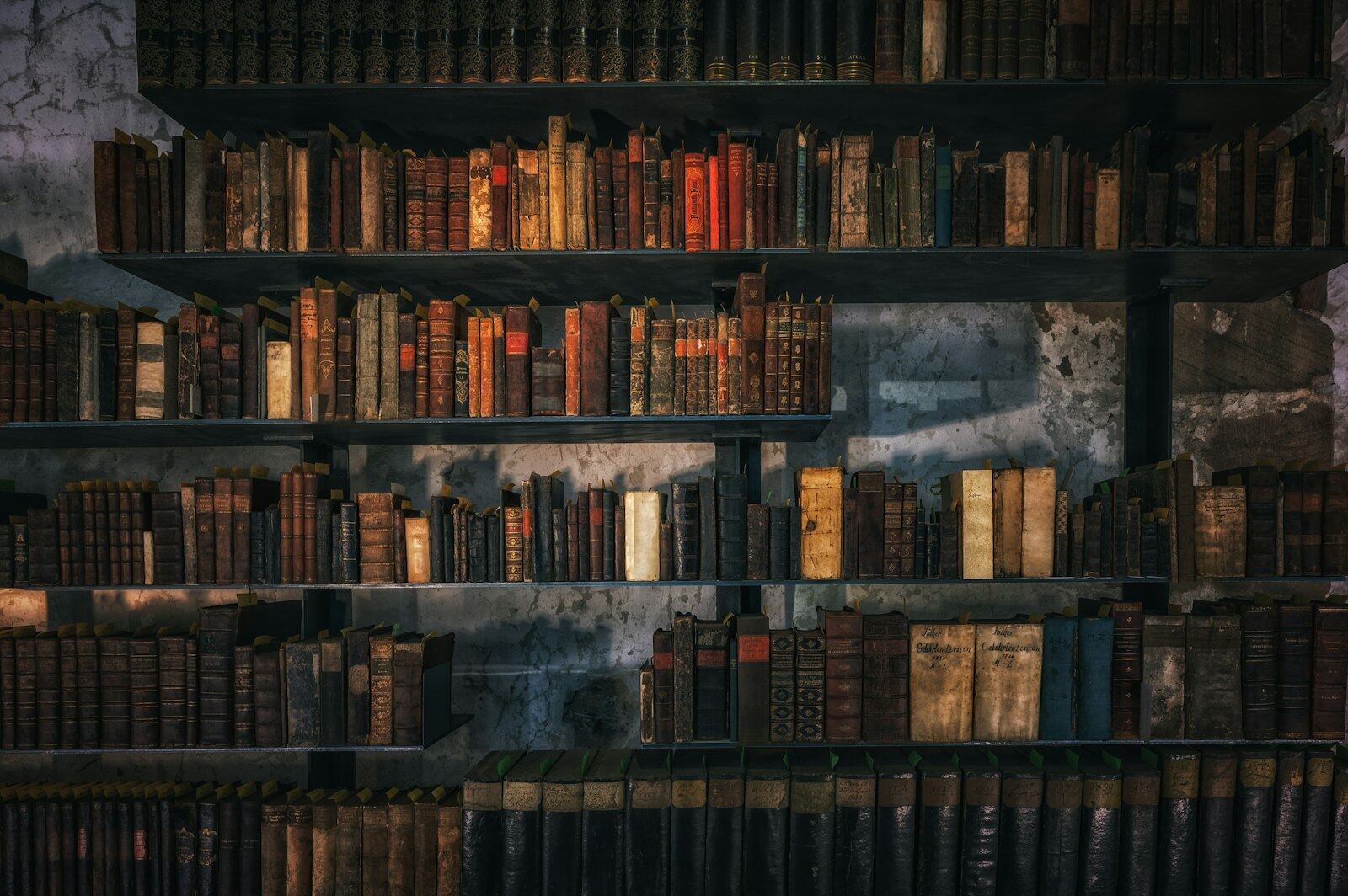 Shelves of antique leather-bound books in an old library