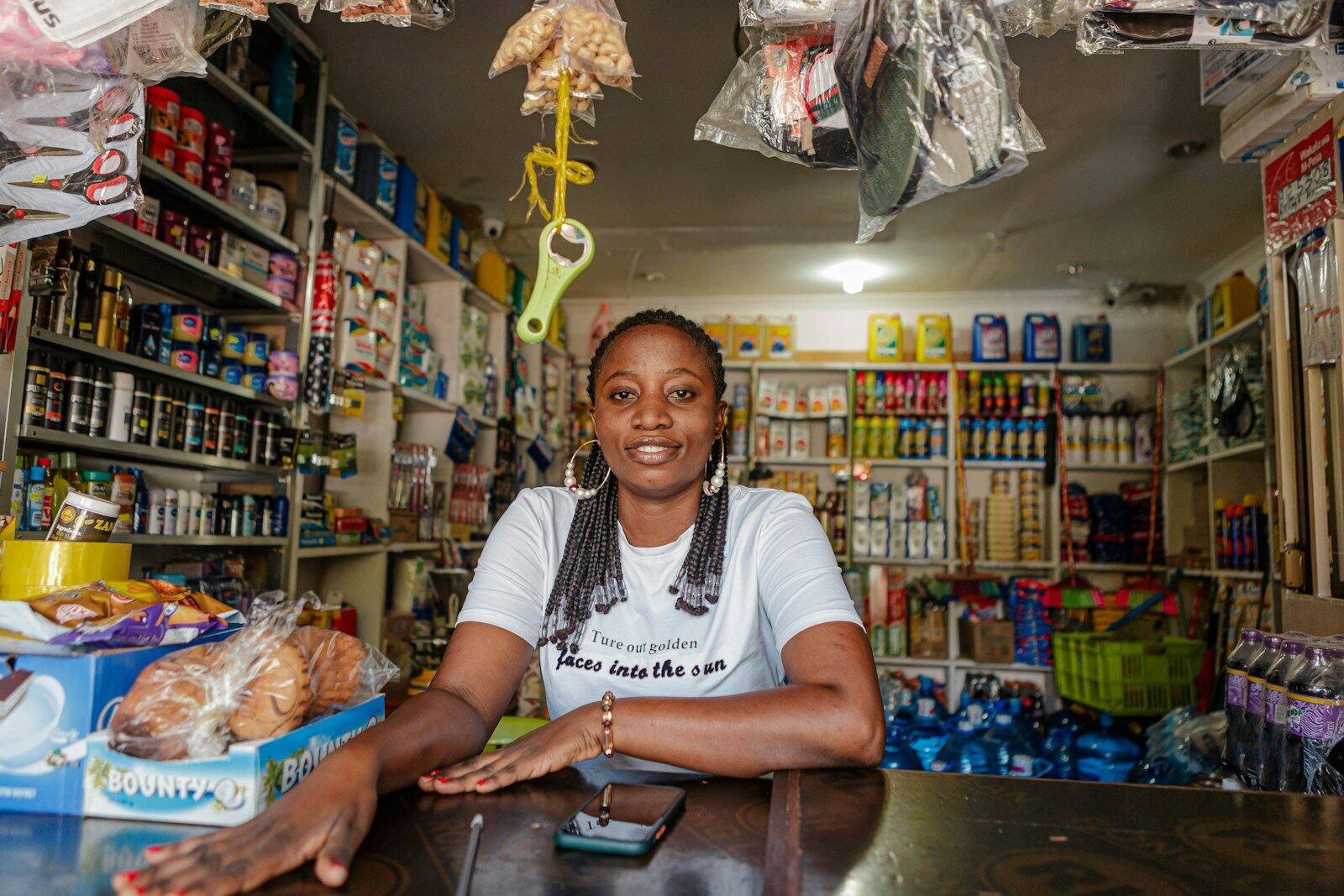 A small business owner sitting at the counter of her store