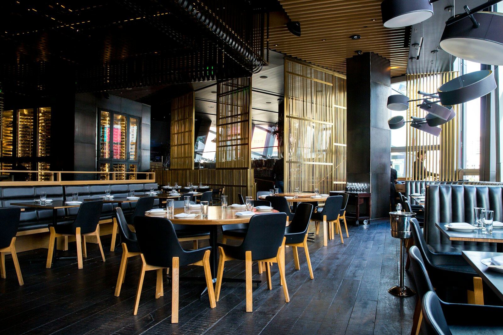 Restaurant dining room with wooden tables and warm pendant lighting